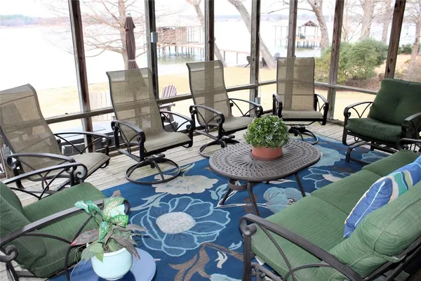 a view of a livingroom with furniture and a floor to ceiling window