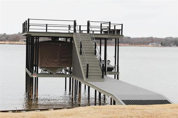 a view of balcony with wooden floor and lake view