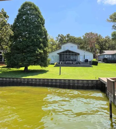 a view of a swimming pool with outdoor seating and a garden