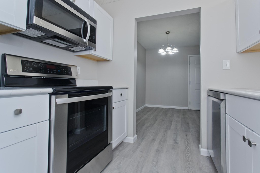 34 Maple Crest Circle, Unit D Holyoke, MA 01040 - Photo 11 of 22 a kitchen with a stove and a microwave