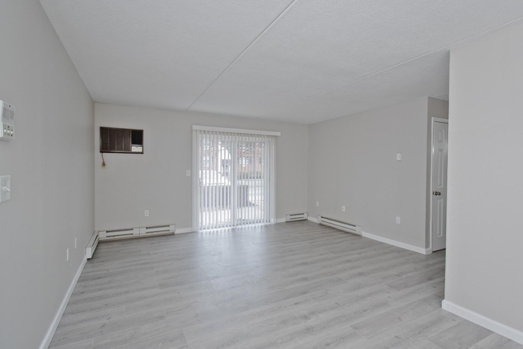 34 Maple Crest Circle, Unit D Holyoke, MA 01040 - Photo 2 of 22 an empty room with wooden floor and windows
