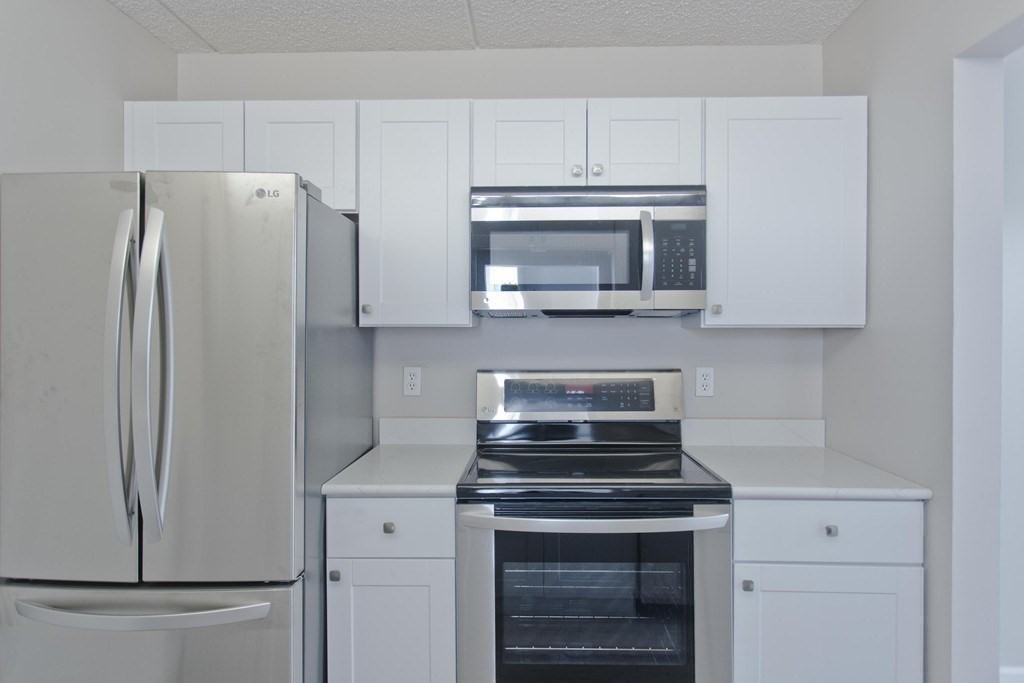 34 Maple Crest Circle, Unit D Holyoke, MA 01040 - Photo 9 of 22 a kitchen with stainless steel appliances white cabinets and a stove