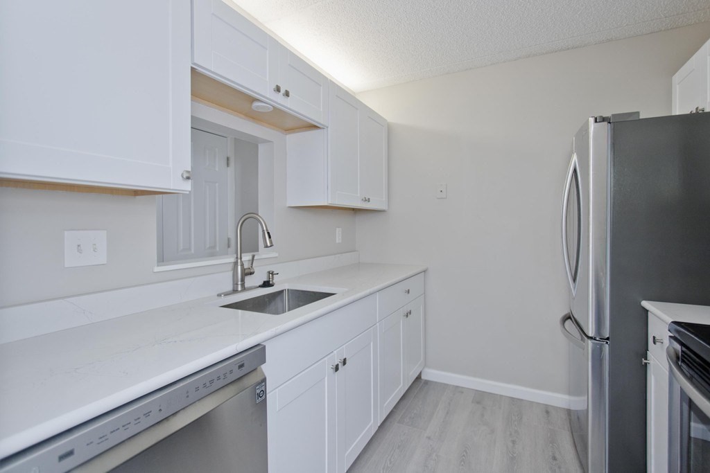 34 Maple Crest Circle, Unit D Holyoke, MA 01040 - Photo 10 of 22 a kitchen with a sink and a refrigerator
