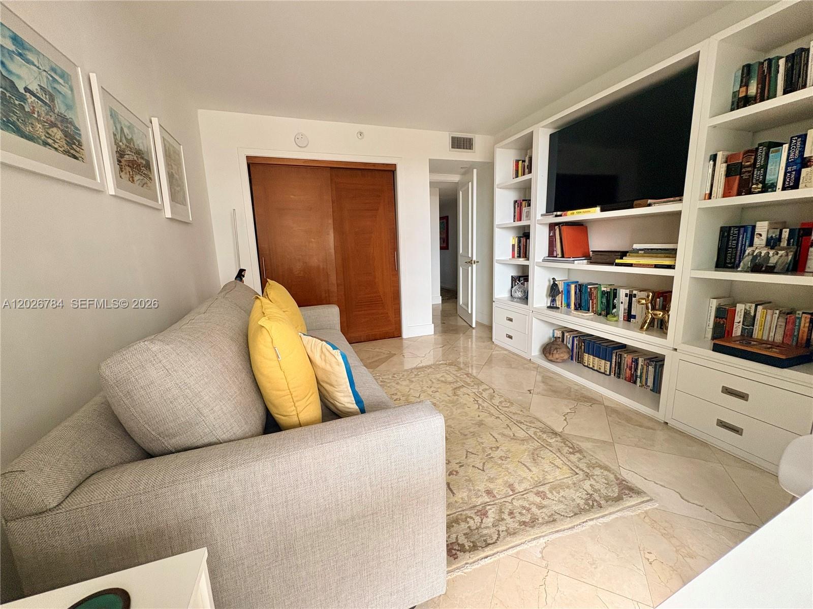 151 Southeast 15th Road, Unit 601 Miami, FL 33129 - Photo 28 of 36 a living room with furniture and a flat screen tv