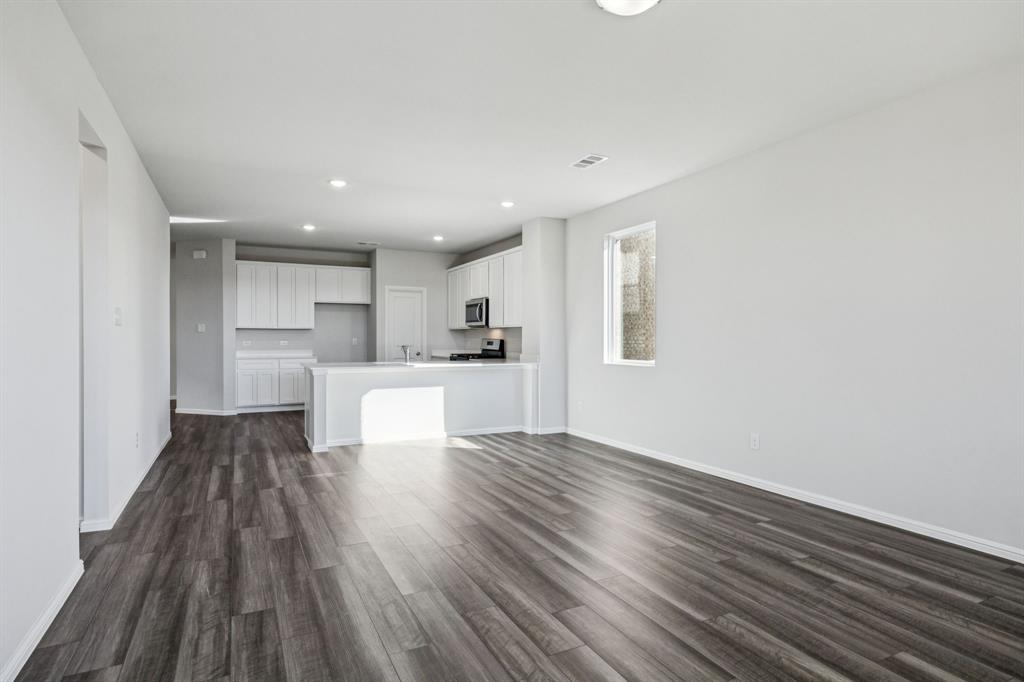 425 Magellan Road Seagoville, TX 75159 - Photo 7 of 36 a view of a kitchen with wooden floor and a window