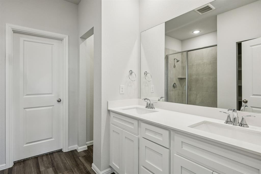 425 Magellan Road Seagoville, TX 75159 - Photo 10 of 36 a bathroom with a sink and a mirror