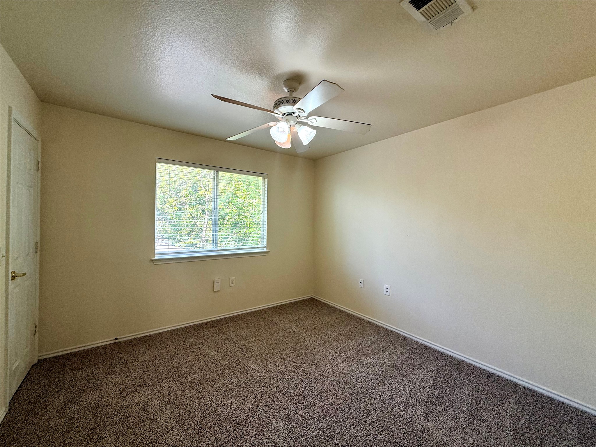 6912 Meador Avenue, Unit A Austin, TX 78752 - Photo 22 of 24 an empty room with a window and a fan