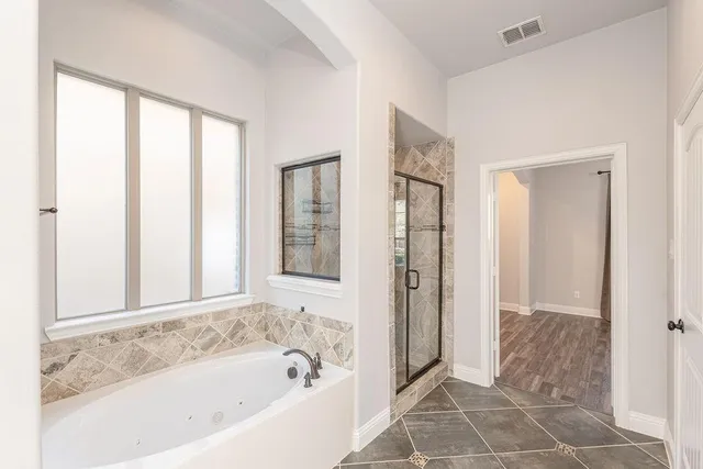 a bathroom with a bathtub and a shower