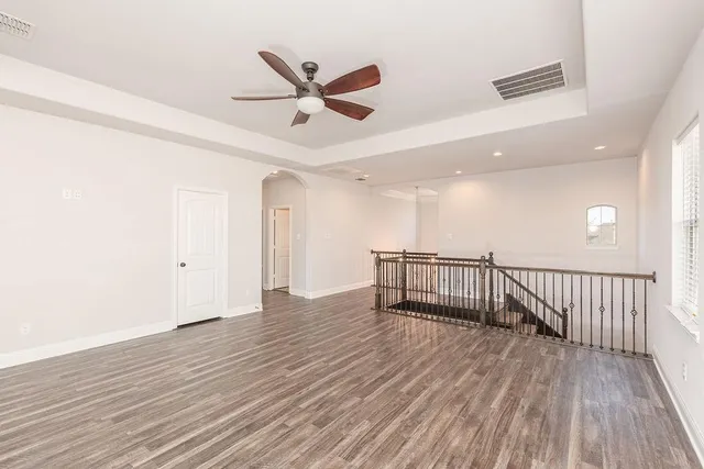 a view of a livingroom with wooden floor and white walls
