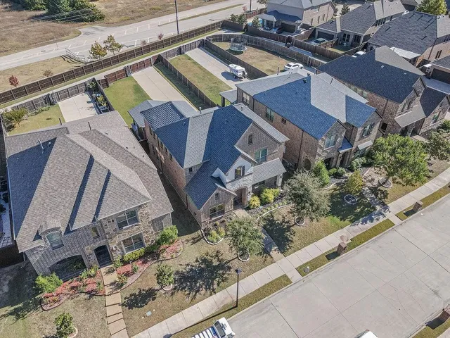 an aerial view of a house with a yard