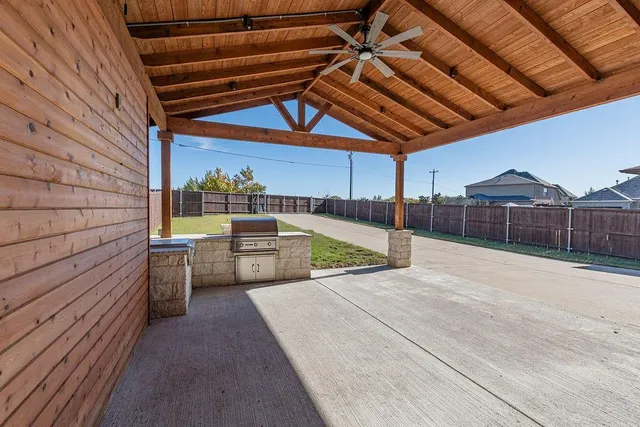 a view of a backyard with sitting area