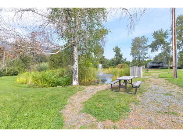 a view of a park with bench in the garden