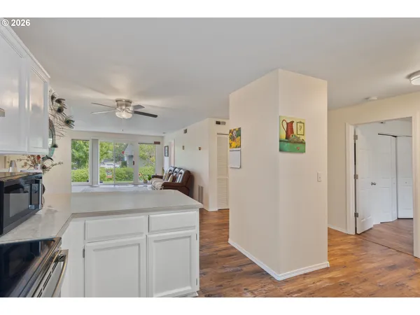 a kitchen with kitchen island a counter top space a sink stainless steel appliances and cabinets