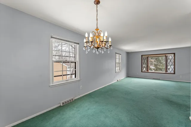 a view of empty room with window and ceiling fan