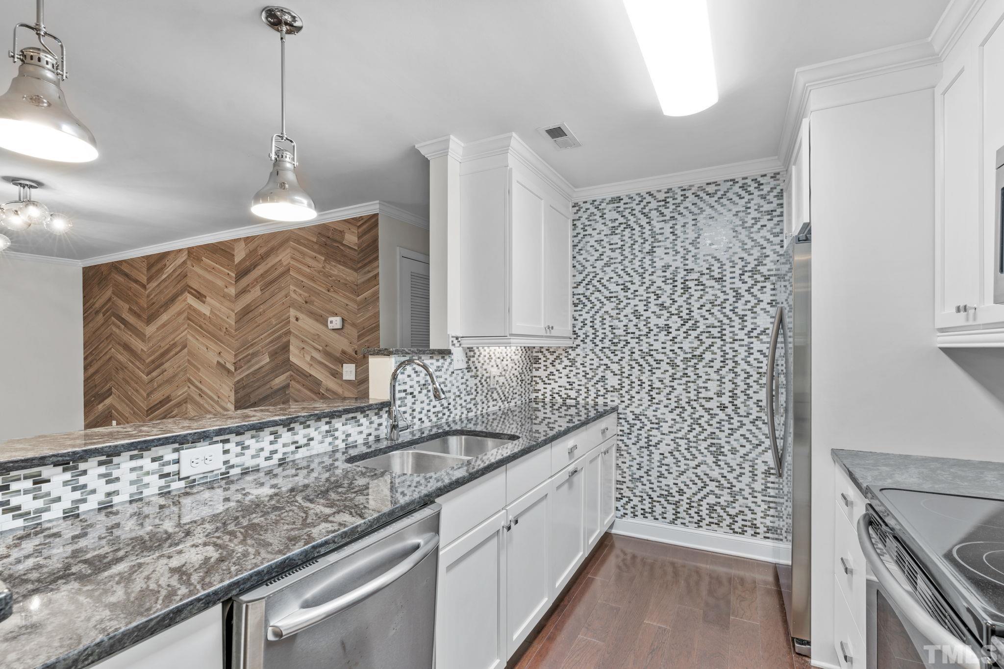 4505 Edwards Mill Road, Unit G Raleigh, NC 27612 - Photo 1 of 31 a bathroom with a granite countertop sink a vanity and a shower