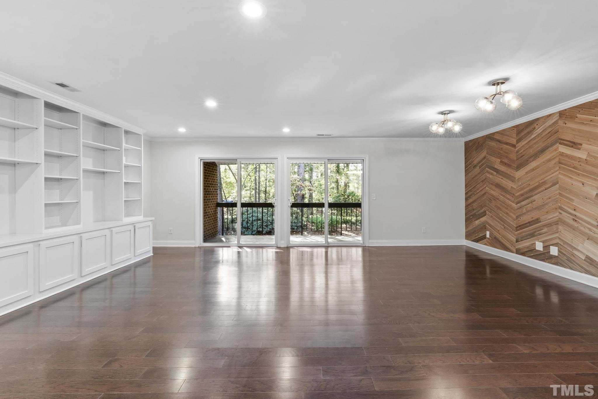 4505 Edwards Mill Road, Unit G Raleigh, NC 27612 - Photo 11 of 31 a view of an empty room with wooden floor and a window