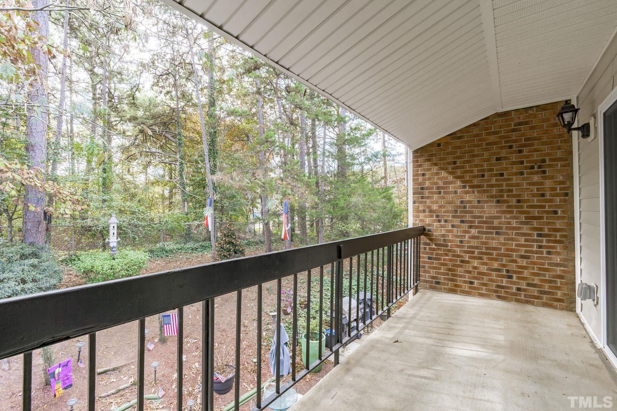 4505 Edwards Mill Road, Unit G Raleigh, NC 27612 - Photo 14 of 31 a view of balcony with wooden floor and fence