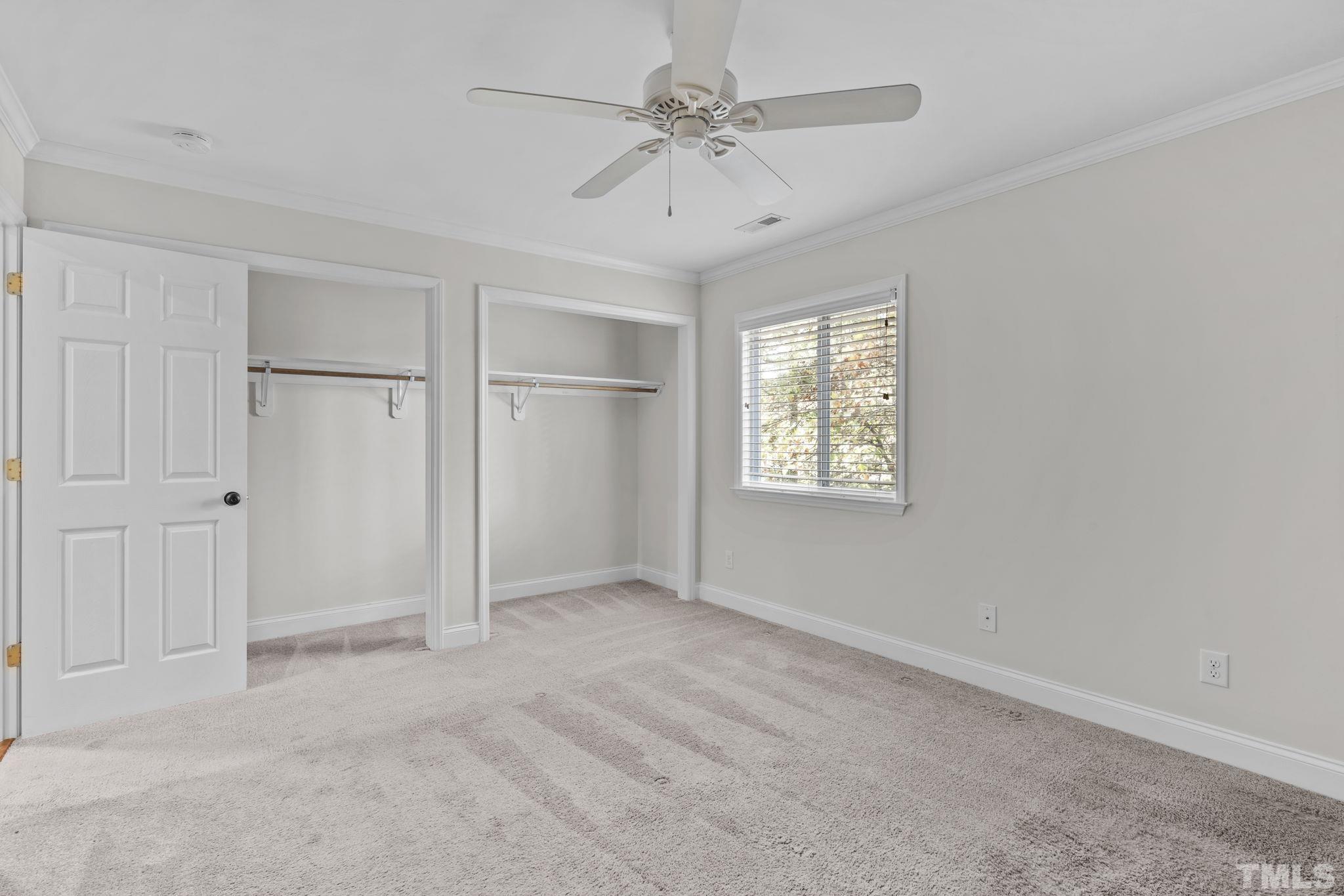4505 Edwards Mill Road, Unit G Raleigh, NC 27612 - Photo 16 of 31 an empty room with windows and fan