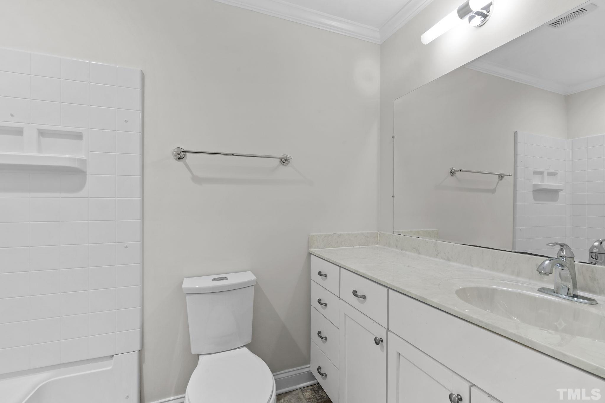 4505 Edwards Mill Road, Unit G Raleigh, NC 27612 - Photo 19 of 31 a bathroom with a sink toilet vanity and tub