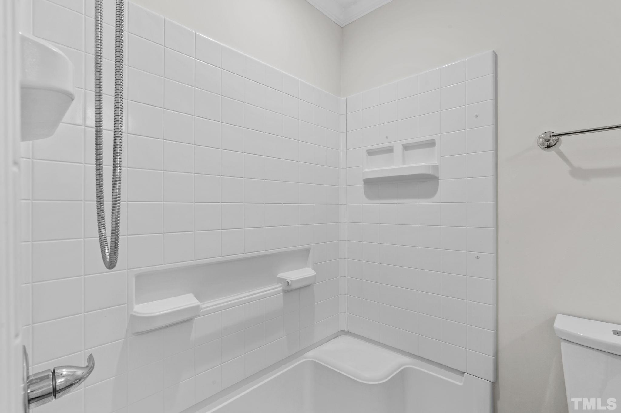 4505 Edwards Mill Road, Unit G Raleigh, NC 27612 - Photo 20 of 31 a bathroom with a shower and toilet