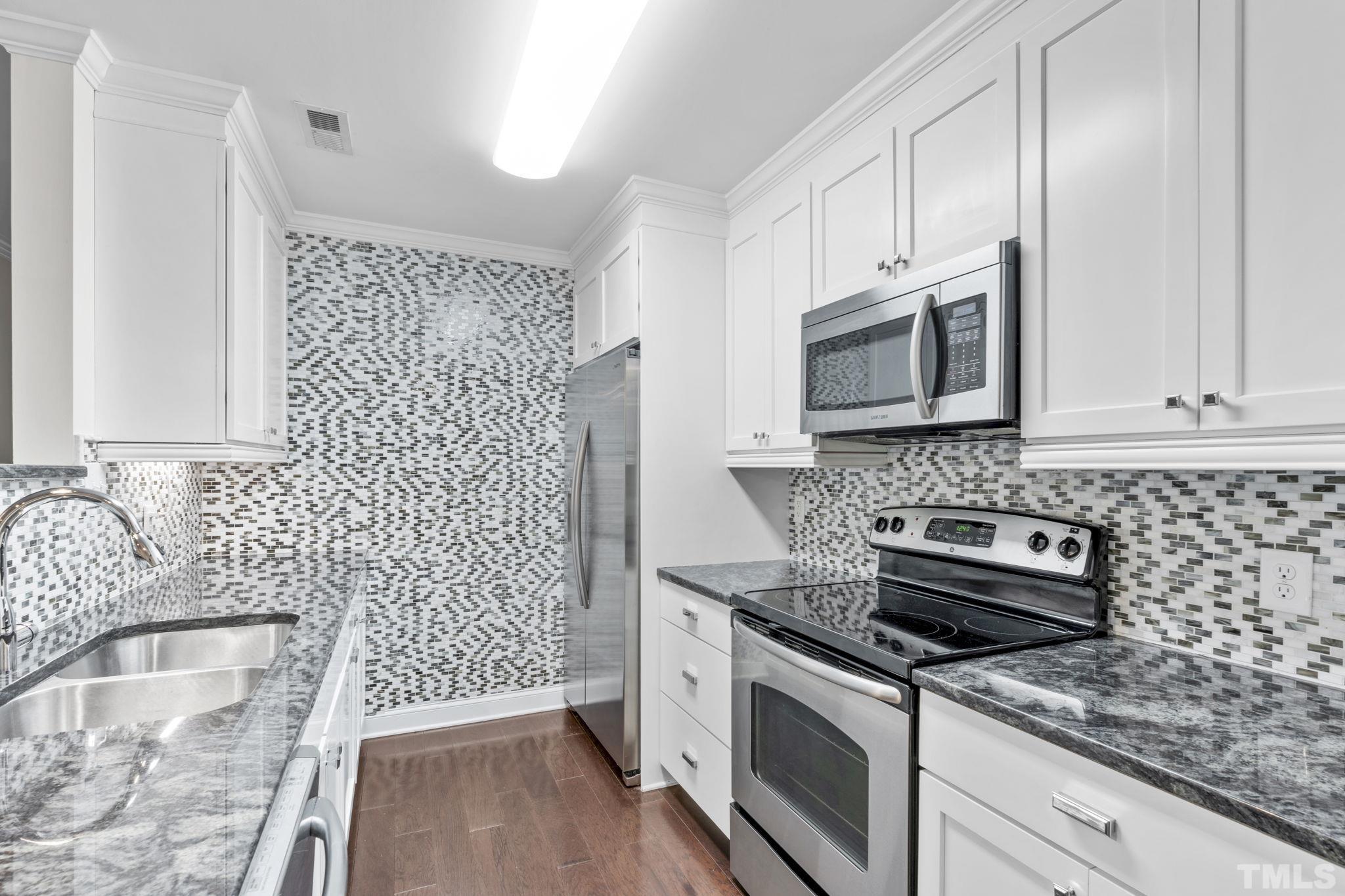 4505 Edwards Mill Road, Unit G Raleigh, NC 27612 - Photo 2 of 31 a kitchen with a sink stove and microwave