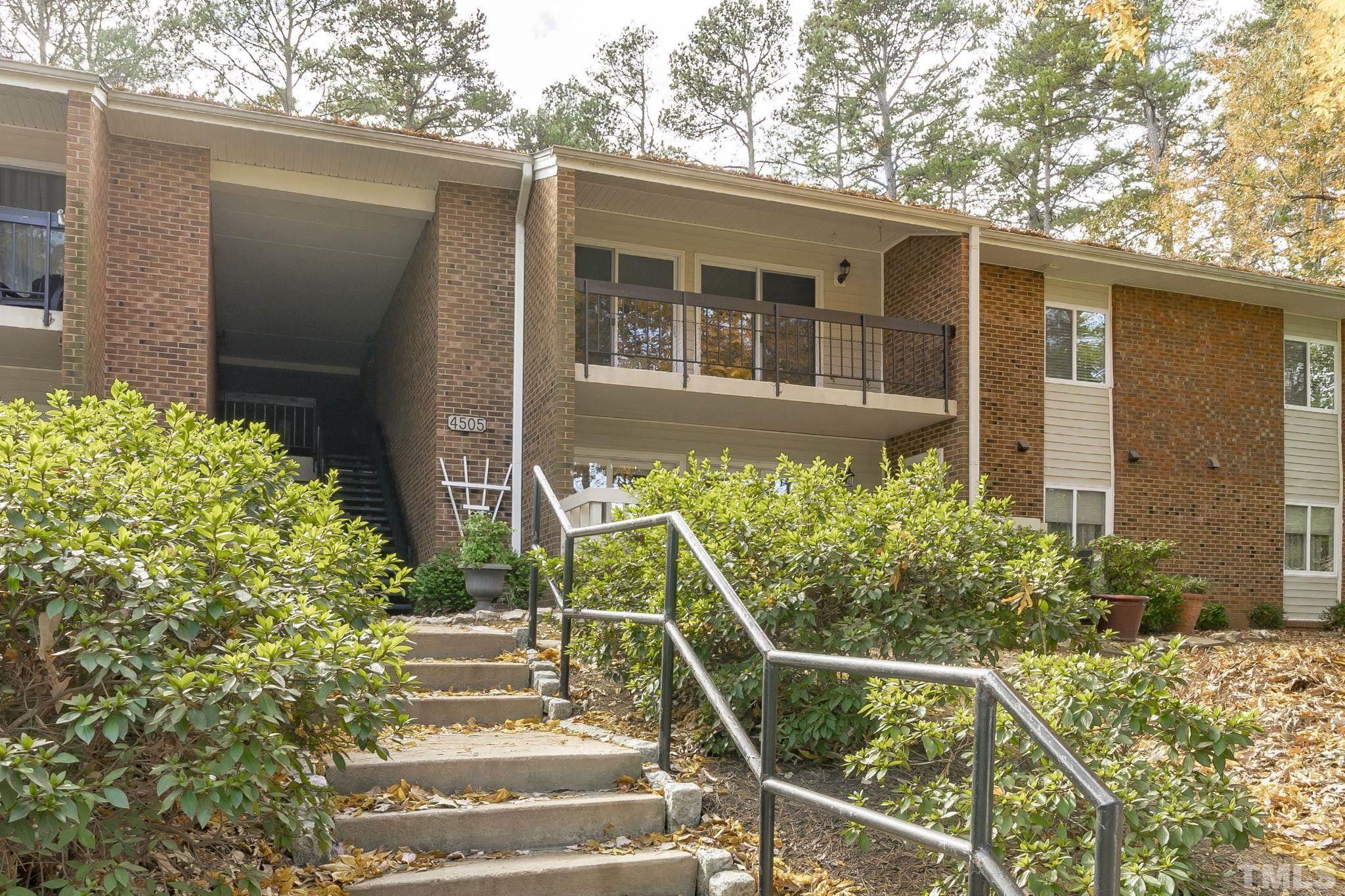4505 Edwards Mill Road, Unit G Raleigh, NC 27612 - Photo 28 of 31 a front view of a house with plants