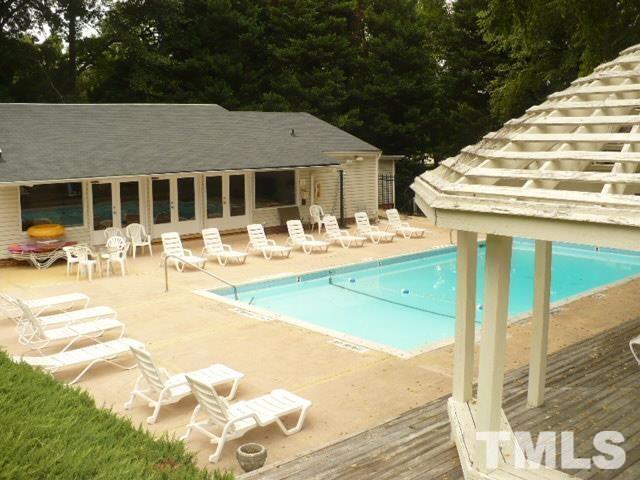 4505 Edwards Mill Road, Unit G Raleigh, NC 27612 - Photo 30 of 31 a view of a house with pool and chairs