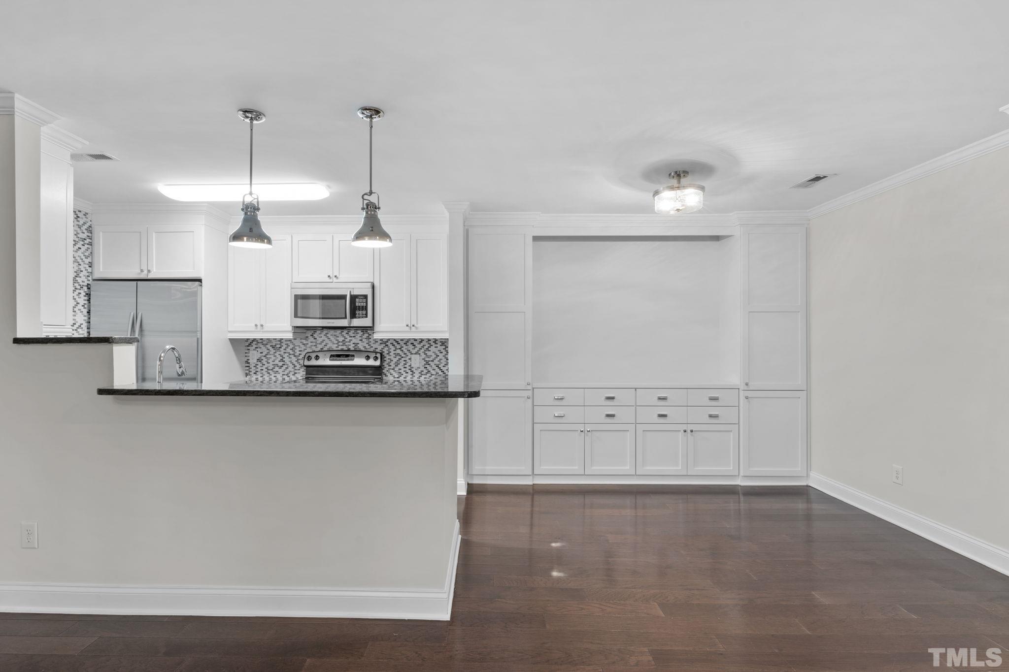 4505 Edwards Mill Road, Unit G Raleigh, NC 27612 - Photo 5 of 31 a kitchen with stainless steel appliances a refrigerator and cabinets