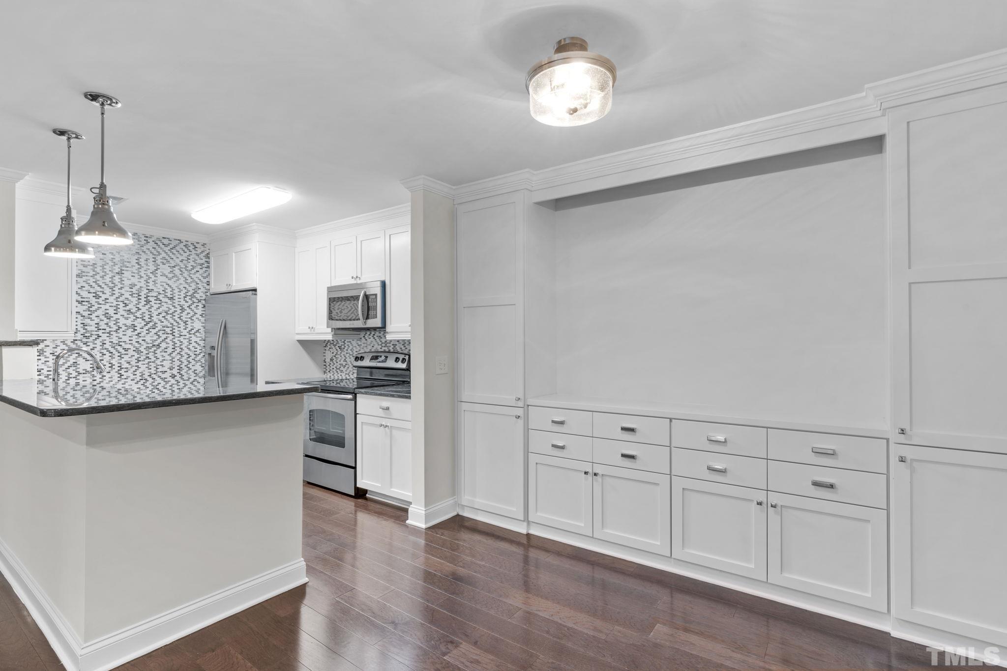 4505 Edwards Mill Road, Unit G Raleigh, NC 27612 - Photo 7 of 31 a kitchen with white cabinets and sink
