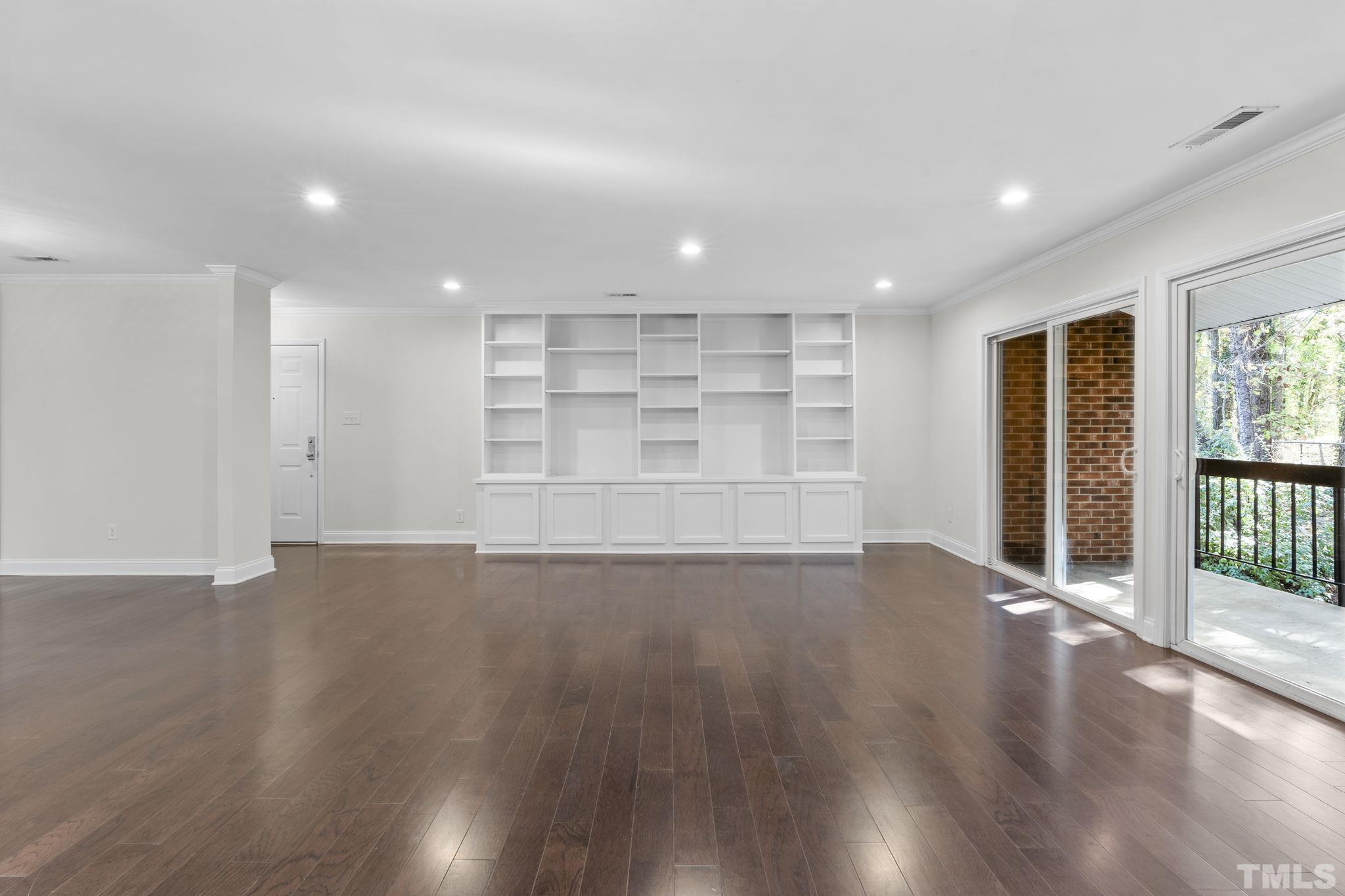 4505 Edwards Mill Road, Unit G Raleigh, NC 27612 - Photo 10 of 31 a view of an empty room with wooden floor and a window