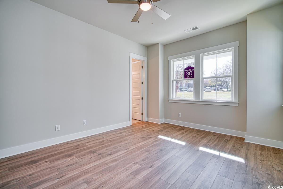 3810 Richardson Street Loris, SC 29569 - Photo 21 of 40 Empty room featuring wood finished floors and a ceiling fan