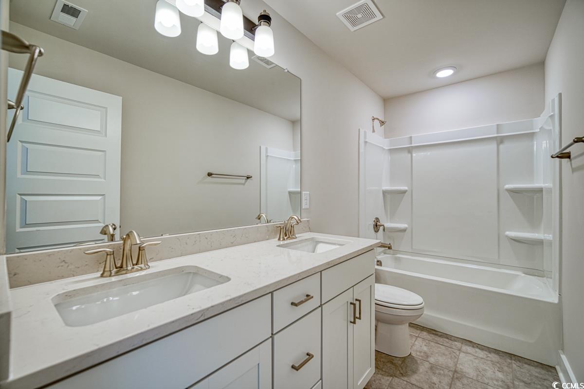 3810 Richardson Street Loris, SC 29569 - Photo 33 of 40 Full bathroom featuring double vanity and bathtub / shower combination