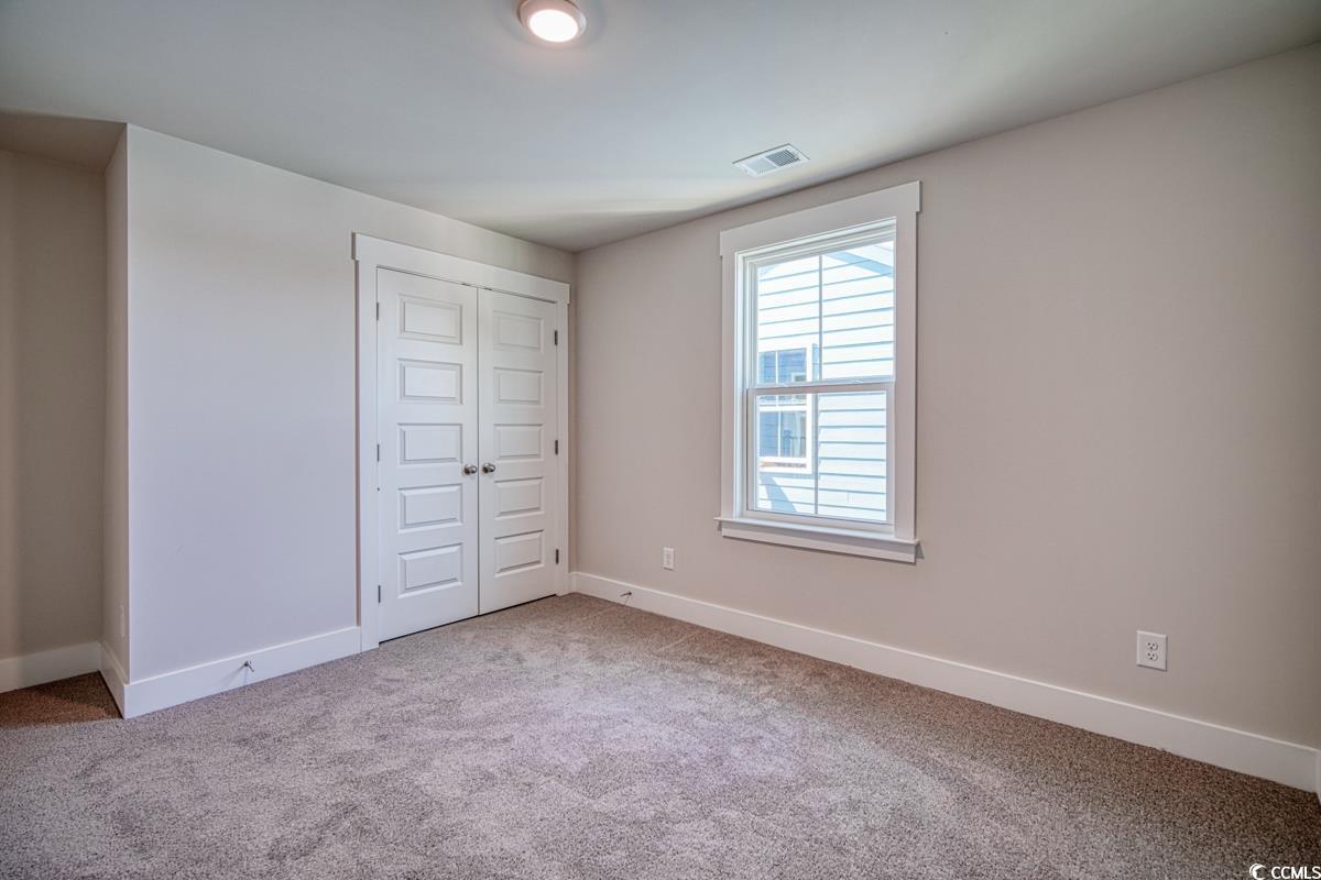 3810 Richardson Street Loris, SC 29569 - Photo 35 of 40 Unfurnished bedroom with light carpet and a closet