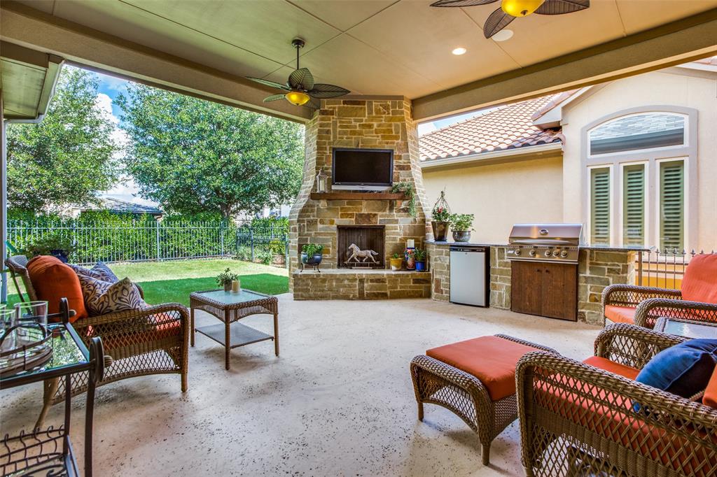 a outdoor living space with furniture potted plant and a fireplace