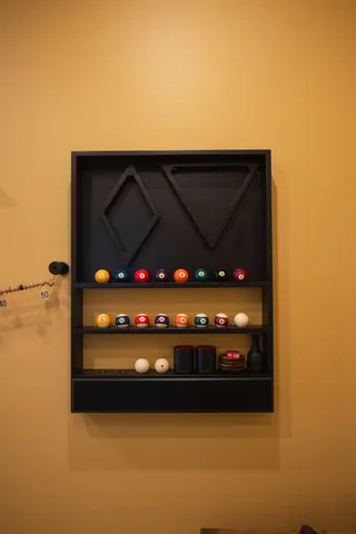 a view of a big house in front of a big yard with plants and large tree