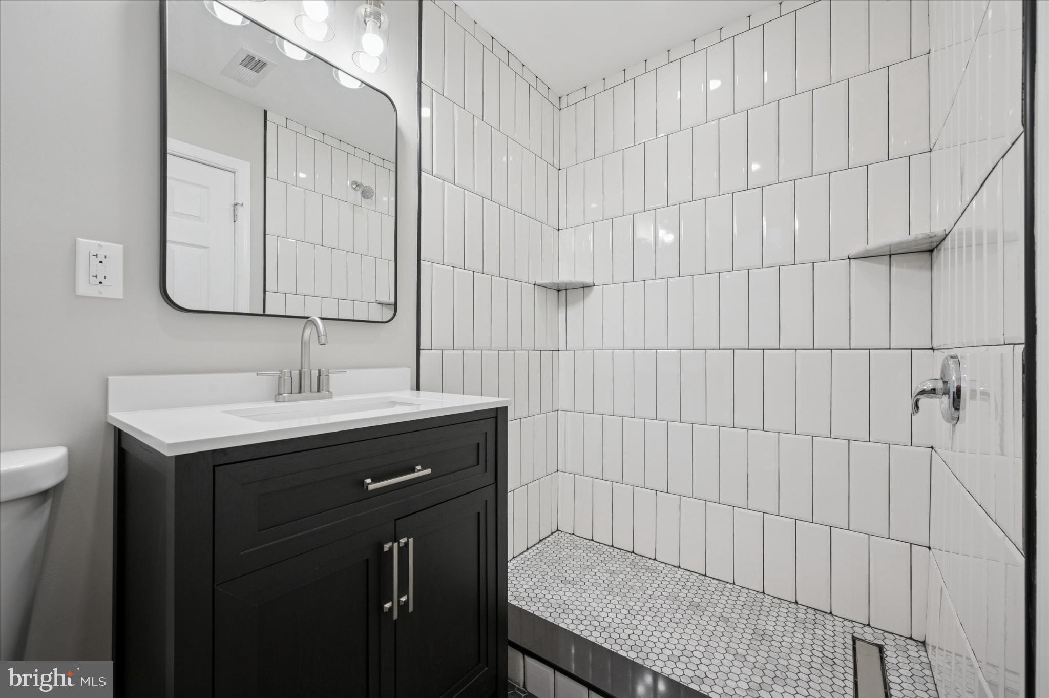 6416 North 15th Street Philadelphia, PA 19126 - Photo 17 of 23 a bathroom with a sink and a mirror