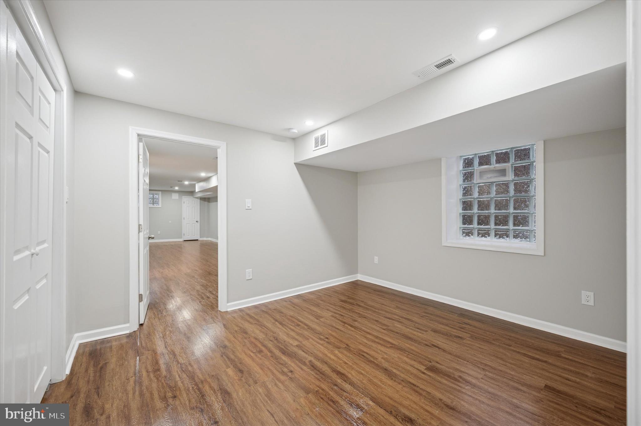 6416 North 15th Street Philadelphia, PA 19126 - Photo 21 of 23 a view of an empty room with wooden floor and a window