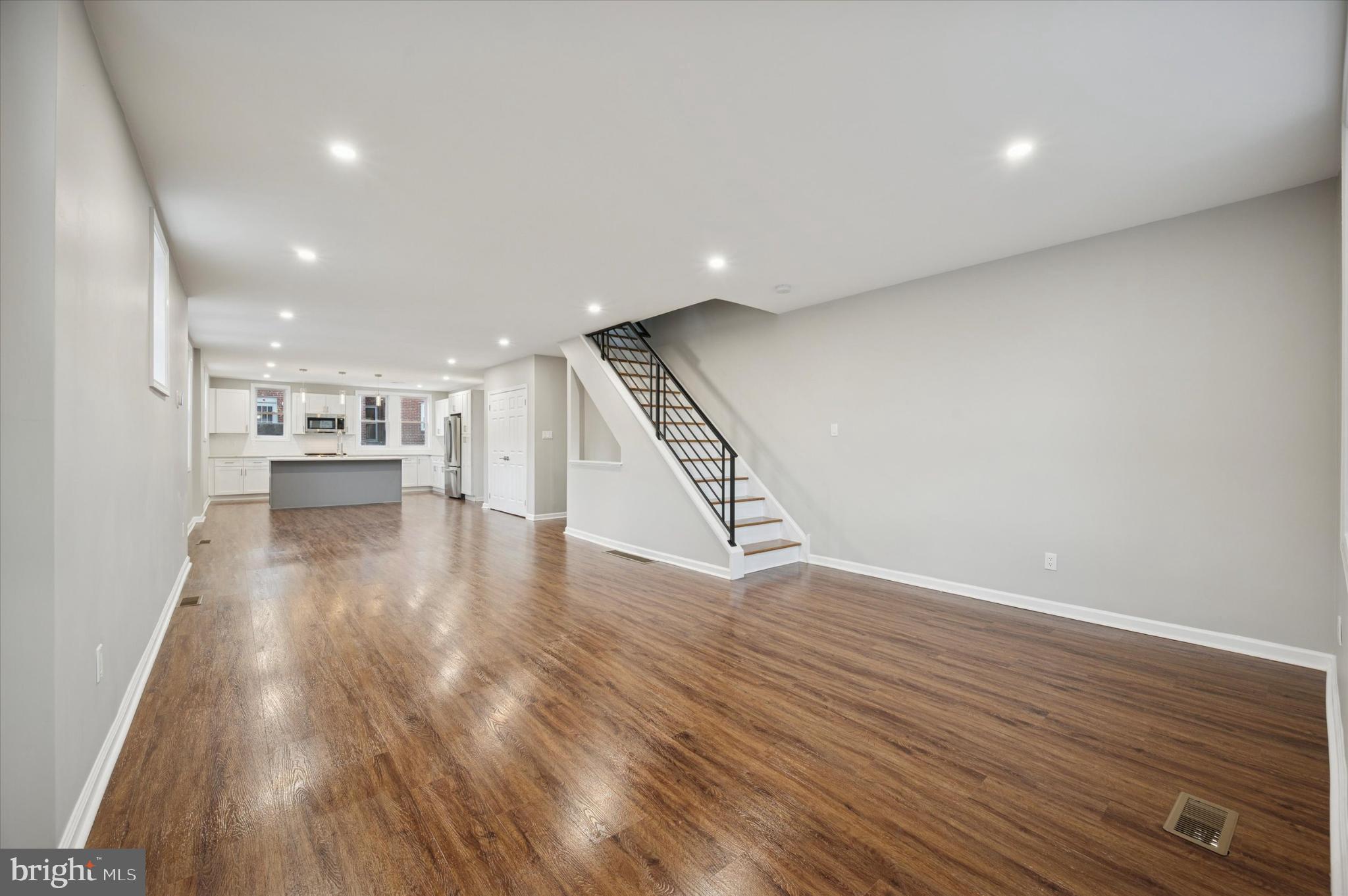 6416 North 15th Street Philadelphia, PA 19126 - Photo 3 of 23 a view of an empty room with wooden floor kitchen view and a window