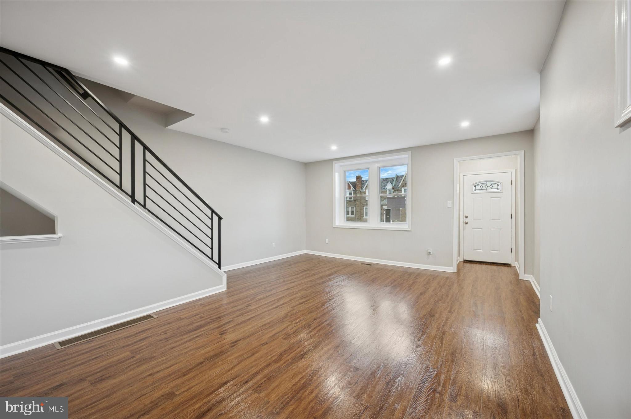 6416 North 15th Street Philadelphia, PA 19126 - Photo 4 of 23 a view of an empty room with wooden floor and stairs