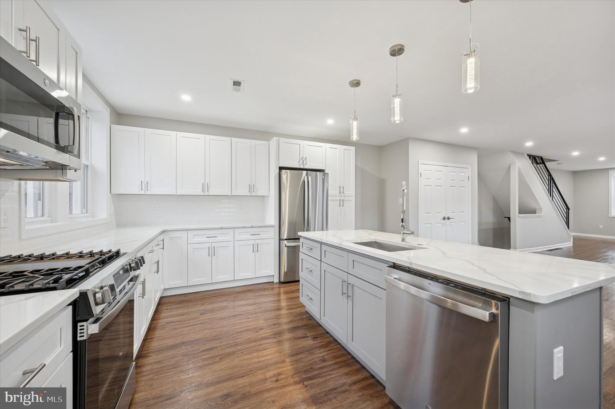6416 North 15th Street Philadelphia, PA 19126 - Photo 8 of 23 a kitchen with a sink stove and cabinets