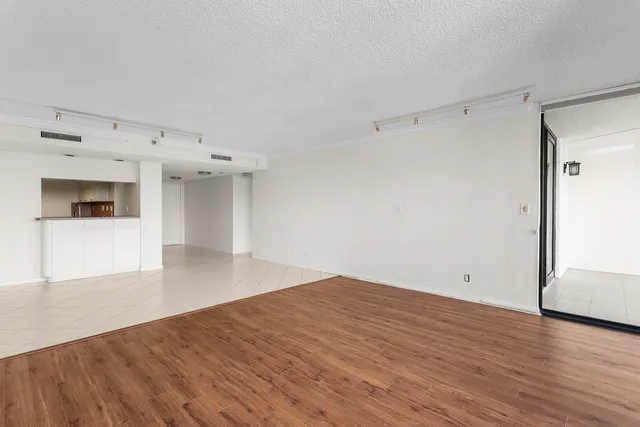 a view of a room with wooden floor and white walls