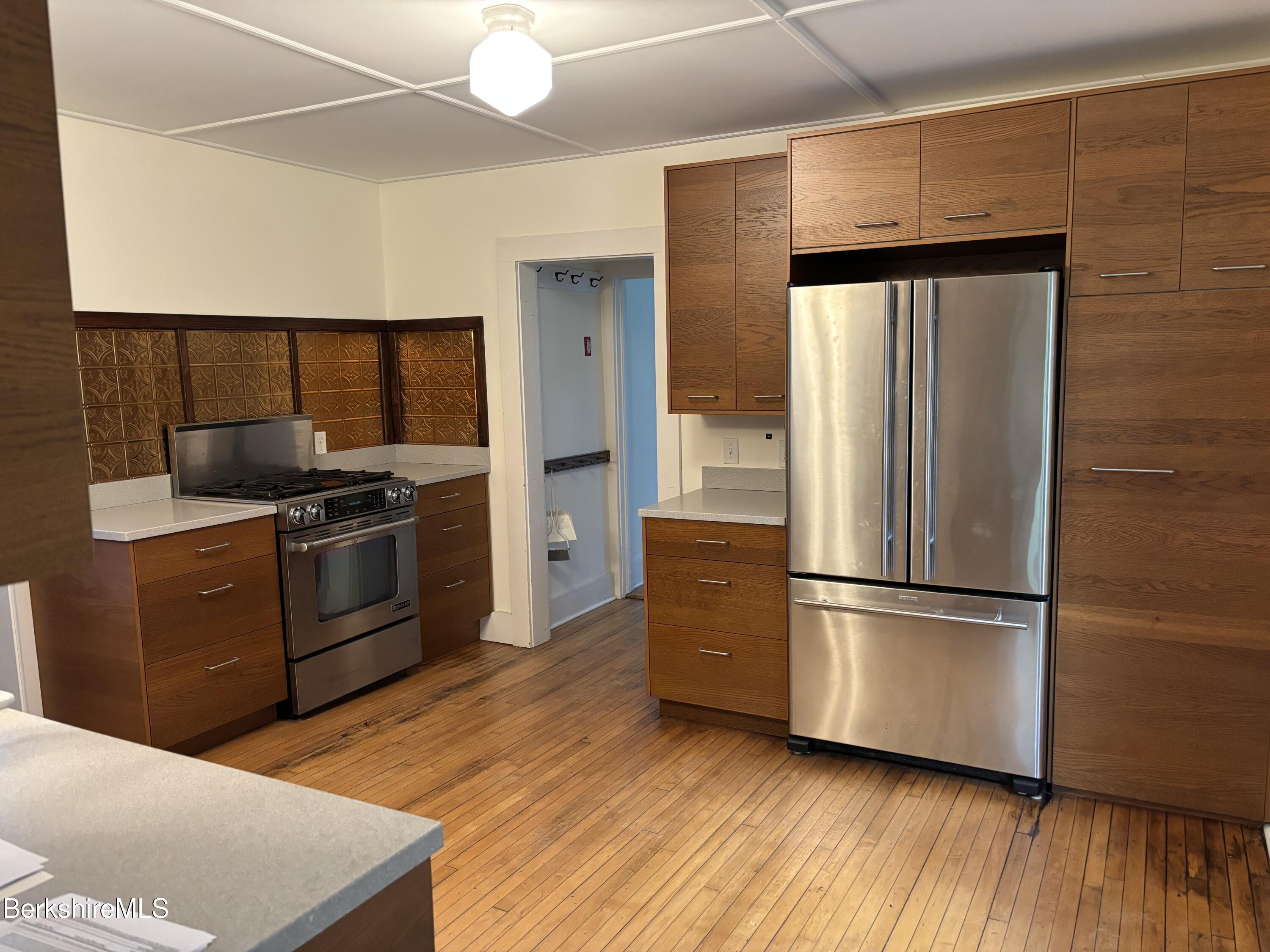 86 Miner Road Lanesborough, MA 01237 - Photo 26 of 44 a kitchen with a refrigerator and a stove top oven
