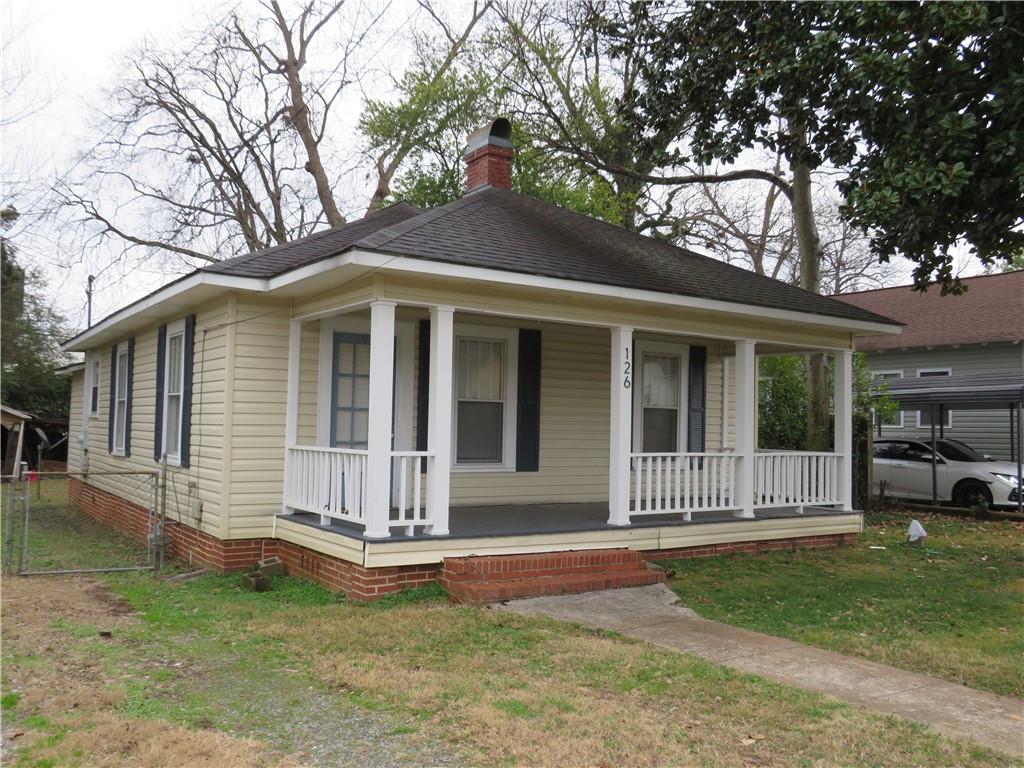 126 Marshall Street Cedartown, GA 30125 - Photo 2 of 12 a front view of a house with a garden