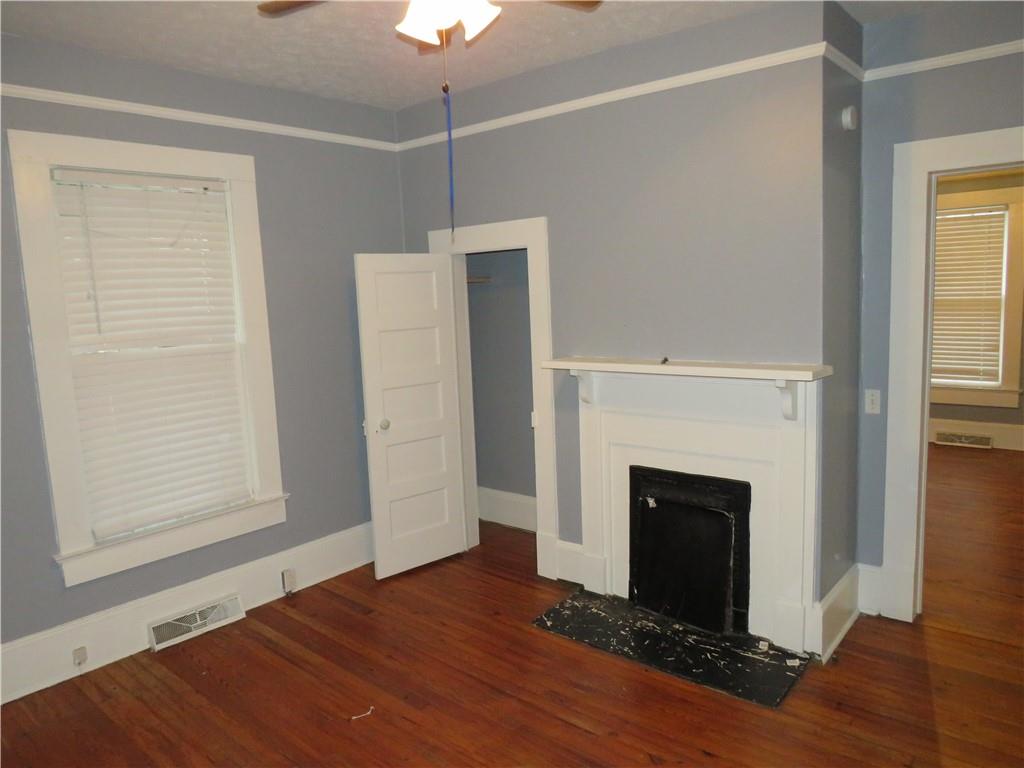 126 Marshall Street Cedartown, GA 30125 - Photo 6 of 12 a view of empty room with wooden floor and fireplace