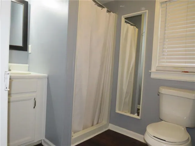 a white toilet sitting next to a bathroom sink