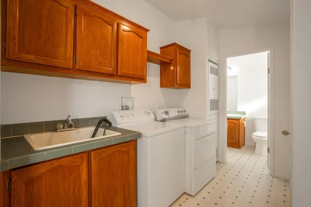 a utility room with sink dryer and washer