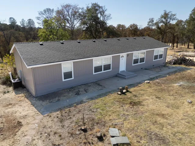 a aerial view of a house with a yard