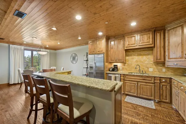 a kitchen with a dining table chairs and white cabinets