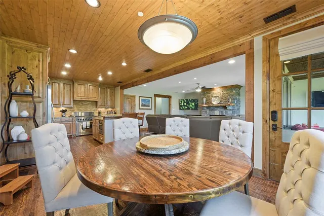 a dining room with furniture and a wooden floor