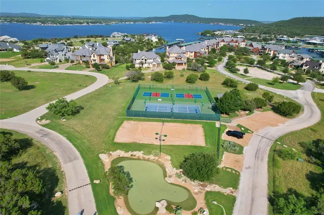 an aerial view of a house with a swimming pool lake view and mountain view